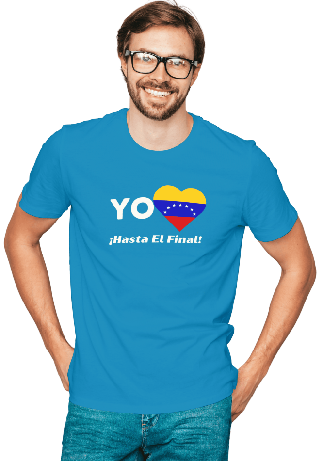 A man is wearing a blue unisex t-shirt featuring a heart-shaped Venezuelan flag, the word "Yo" on the left, and the text "¡Hasta El Final!" reading below. He is smiling with glasses.