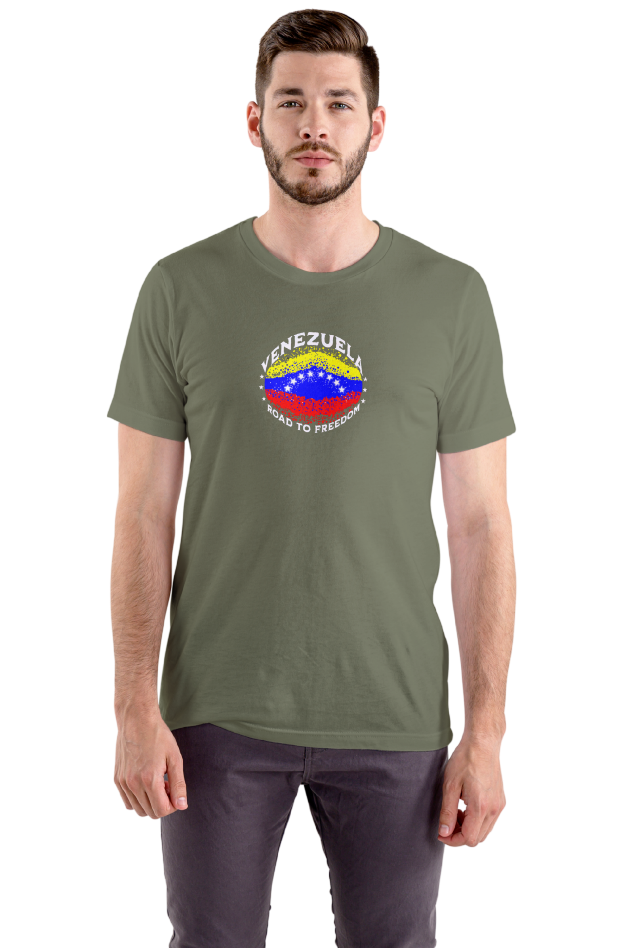 A man wears an olive-green T-shirt featuring an elliptical Venezuelan flag dotted with dots (like an explosion), with the word "VENEZUELA” at the top, the text “ROAD TO FREEDOM” below the flag, and 3 stars on each side.