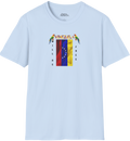 Light blue T-shirt featuring the 7-star Venezuelan flag, the name VENEZUELA at the top, and one macaw on each side. The words WILL BE and FREE are all placed vertically next to the flag.