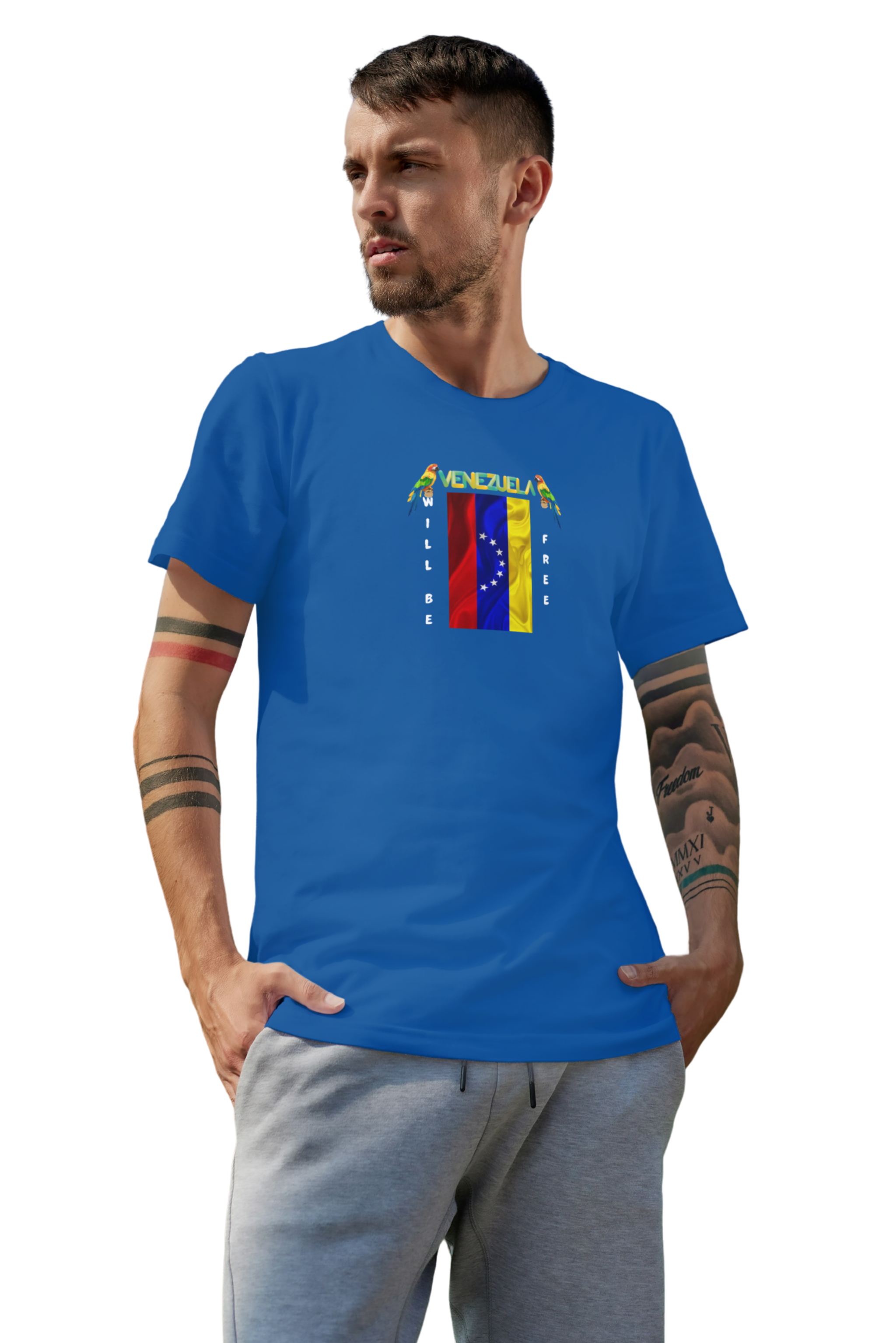 A young man wears a blue T-shirt featuring the 7-star Venezuelan flag, the name VENEZUELA at the top, and one macaw on each side. The words WILL BE and FREE are all placed vertically next to the flag.