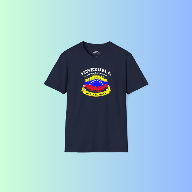 A blue unisex t-shirt featuring a colorful, elliptically shaped Venezuelan flag dotted (like an explosion), with the text "Venezuela Camino a La Libertad" at the top and "Hasta El Final" on a yellow ribbon below the flag.