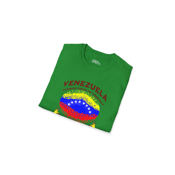 A folded green unisex t-shirt featuring a colorful, elliptically shaped Venezuelan flag dotted (like an explosion), with the text "Venezuela Camino Hacia La Libertad" at the top.