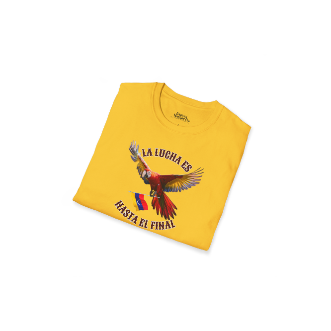 A folded yellow unisex t-shirt featuring a colorful macaw flying while holding the Venezuelan flag. The text "La Lucha Es" is at the top, and "Hasta El Final" is below the macaw. 